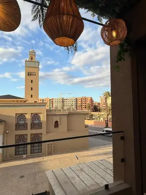 a view of a building with a clock tower at Jnane Guéliz 2CH parking wifi Marrakech centre in Marrakech