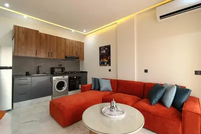 a living room with a red couch and a table at Appartement, Gueliz, WiFi, parking in Marrakech