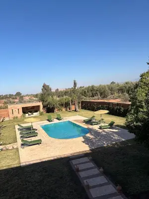 a swimming pool with lounge chairs at NEW Dar Aït Zahra Marrakech-Cook included-View ATLAS in Marrakech