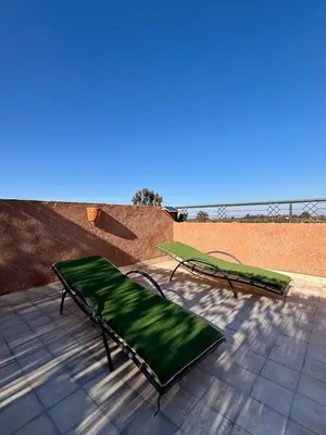 two green beds sitting on a patio at NEW Dar Aït Zahra Marrakech-Cook included-View ATLAS in Marrakech