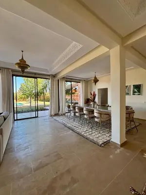 an open living room with a table and chairs at NEW Dar Aït Zahra Marrakech-Cook included-View ATLAS in Marrakech