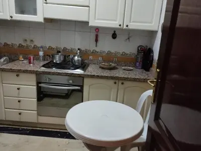 a kitchen with a white stool and a stove at زنقة ابو حنيفه in Marrakech