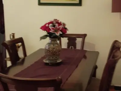 a vase with flowers in it sitting on a table at زنقة ابو حنيفه in Marrakech