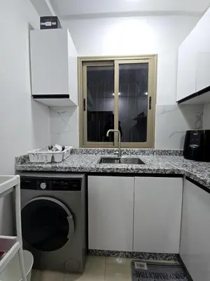 a kitchen with a sink and a washing machine at Cozy and spacious apartment in Marrakech in Marrakech