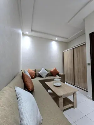 a living room with a couch and a table at Cozy and spacious apartment in Marrakech in Marrakech