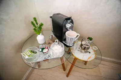 a glass table with a coffee maker on top of it at Élégant avec Parking - Guéliz Hivernage in Marrakech