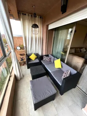 a living room with two couches and a window at Appartement de luxe prestigia agate Marrakech in Marrakech