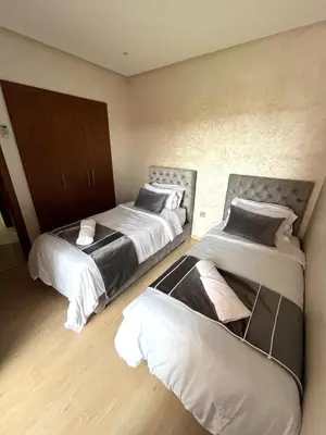 a bedroom with two beds at Appartement de luxe prestigia agate Marrakech in Marrakech
