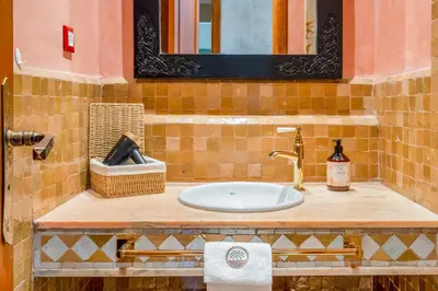 a bathroom counter with a sink and a mirror at Palm Nest in Marrakech