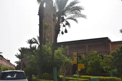 a car parked in front of a building with a palm tree at Riad Zaitone G1 in Marrakech