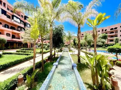 a resort with a swimming pool and palm trees at Luxurious appartement Marrakech - pool&terrace in Marrakech