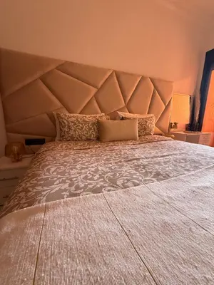 a large bed with a large headboard in a bedroom at Luxurious appartement Marrakech - pool&terrace in Marrakech