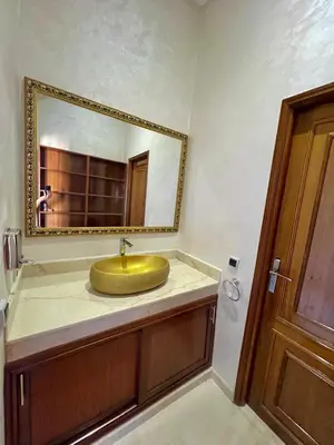 a bathroom with a gold sink and a mirror at Villa De Luxe Marrakech Targa in Marrakech
