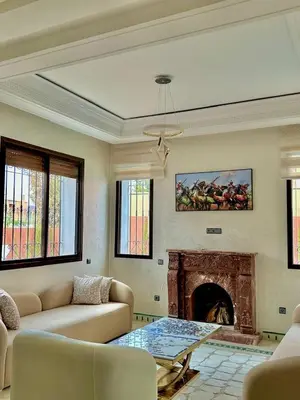 a living room with a couch and a fireplace at Villa De Luxe Marrakech Targa in Marrakech