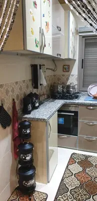 a kitchen with white cabinets and a counter top at Portes de Guéliz in Marrakech