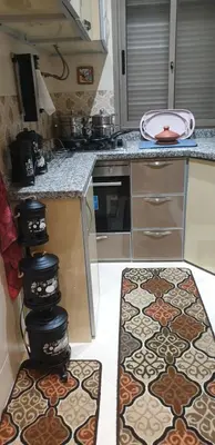 a kitchen with a counter with tiles on the floor at Portes de Guéliz in Marrakech