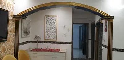 a room with an archway and a room with a table at Portes de Guéliz in Marrakech