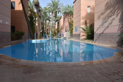 a large swimming pool in the middle of a building at Riad Zaitone 134 in Marrakech