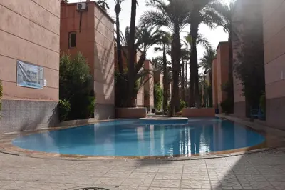 a large blue pool in the middle of a building at Riad Zaitone 134 in Marrakech