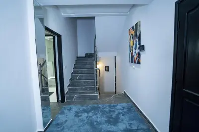 a hallway with stairs with a blue rug at Villa Bonsai Marrakech in Marrakech