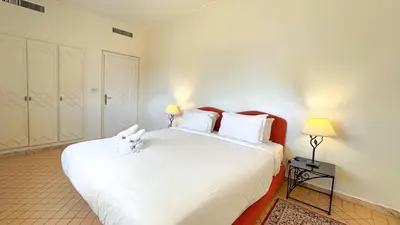 a bedroom with a large white bed with white pillows at Modern Apartment in a Resort Luxury and Comfort in Marrakech