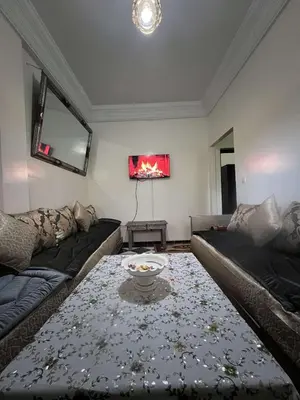 a living room with a couch and a table at Palm Residence in Marrakech