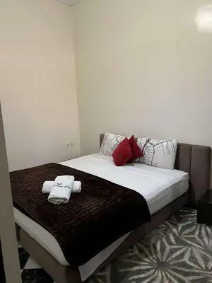 a bedroom with a bed with two towels on it at Palm Residence in Marrakech