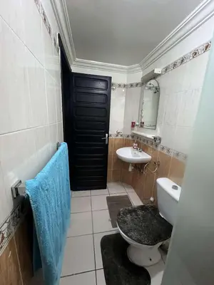 a bathroom with a black door and a toilet and a sink at Palm Residence in Marrakech