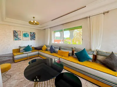 a living room with a large couch with colorful pillows at Luxurious Duplex in a Peaceful Resort in Marrakech in Marrakech