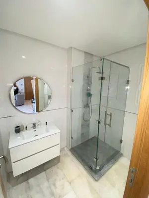 a bathroom with a shower and a sink and a mirror at Riad Garden 1 in Marrakech