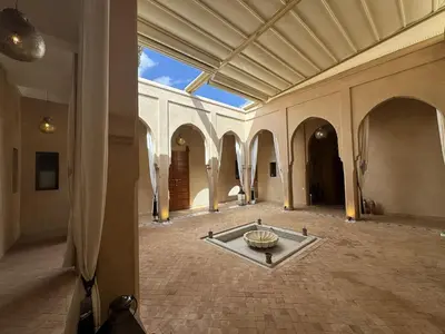 an empty hallway with a fountain in the middle of a building at Villa Hilin - Piscine chauffée et hammam privé proche des golfs et du centre ville in Marrakech
