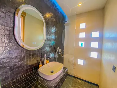 a bathroom with a sink and a mirror at Villa Warda Luxe & Confort in Marrakech