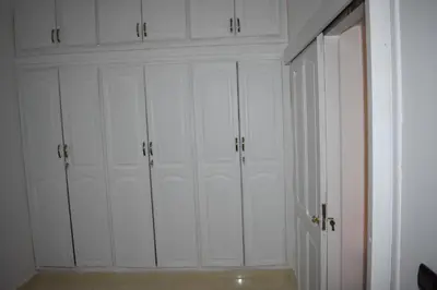 a room with four white closet doors and a wall at Apartment A Zaitone G19 in Marrakech