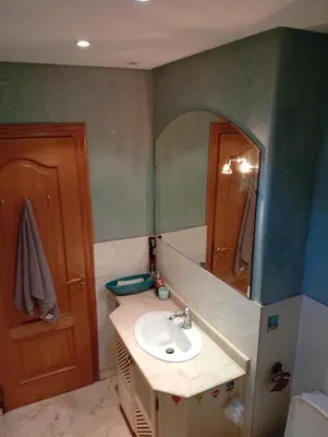 a bathroom with a sink and a mirror at Appartement de luxe Résidence Majorelle in Marrakech