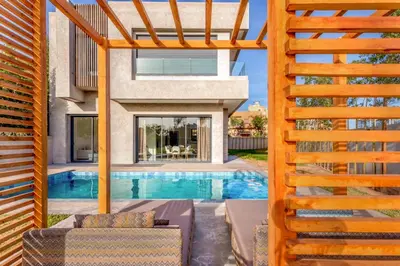 a house with a swimming pool and a wooden fence at Villa Esma in Marrakech