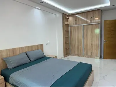 a bedroom with a bed and a sliding glass door at Studio de luxe à Gueliz Marrakech in Marrakech