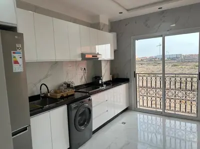 a kitchen with a washing machine and a balcony at Studio de luxe à Gueliz Marrakech in Marrakech