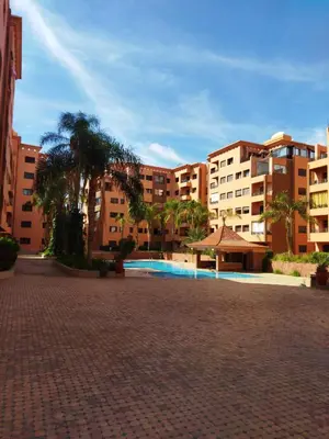 a courtyard with a swimming pool in a building at Résidence Babylone Y - Appartement Studio in Marrakech