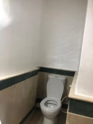 a bathroom with a white toilet in a stall at Résidence Babylone Y - Appartement Studio in Marrakech