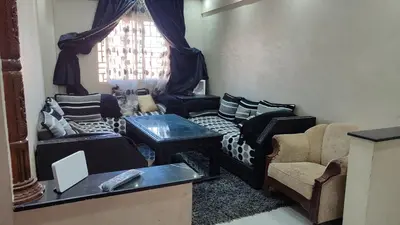 a living room with couches and chairs and a window at Saada 15 marrakech in Marrakech