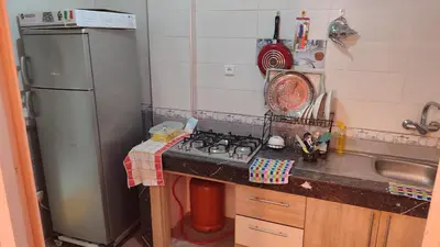 a small kitchen with a stove and a sink at Saada 15 marrakech in Marrakech