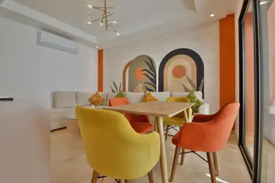 a dining room with a table and chairs at Appartement Domaine de Noria 7 in Marrakech