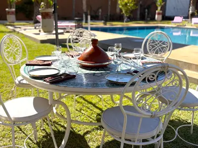 a table with glasses and a tea pot on top of it at Palais Bohemia in El Rhechat