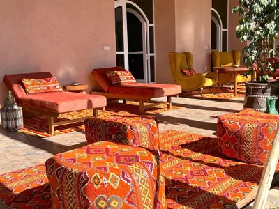 a room with several chairs and ottomans at Palais Bohemia in El Rhechat