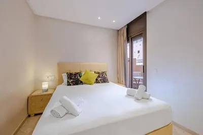 a bedroom with a large white bed and a window at Brand New and Stylish appart hotel Best location in Marrakech