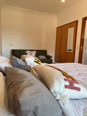 a bedroom with three pillows on a bed at Cosy Appartement Avec Piscine, Terrain tennis et loisirs in Marrakech