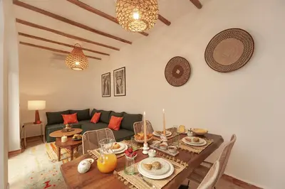 a living room with a table and a couch at Riad Deva Lina in Marrakech