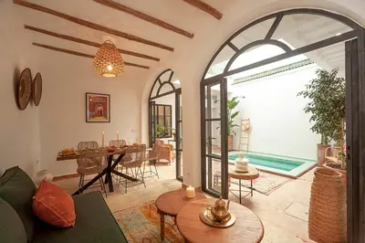 a living room with a table and a dining room at Riad Deva Lina in Marrakech