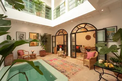 a living room with a swimming pool in a house at Riad Deva Lina in Marrakech