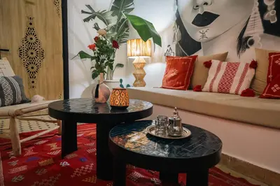 a living room with two tables and a couch at Riad Le Soleil de Bahia in Marrakech